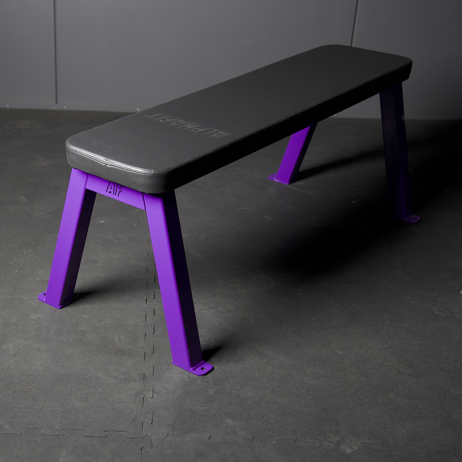 AlphaFit Flat Utility Bench with a purple steel frame and black pad